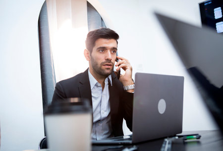 Executives hold team meetings via computers.の写真素材