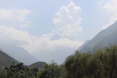 Stunning views of the mountain draped with thick cloudsの写真素材