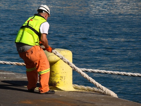 Dockworker hauling ropesの写真素材