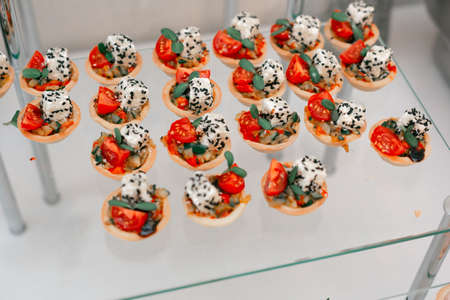 A set of beautiful canapes on plates. Buffet table. Catering.