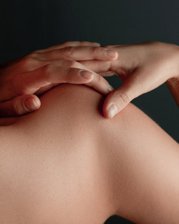 Beautiful female hands, perfect white skin, tattoos on black backgroundの写真素材