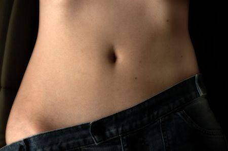 Woman's stomach pants at angle.の写真素材