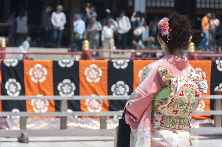 A young japanese lady with traditional costume at a temple in Tokyo, Japan - CIRCA April 2012.のeditorial素材
