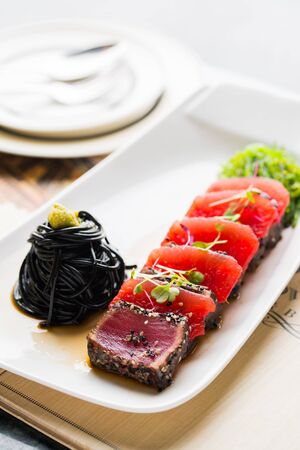Black Spaghetti with Salmon on the tableの写真素材