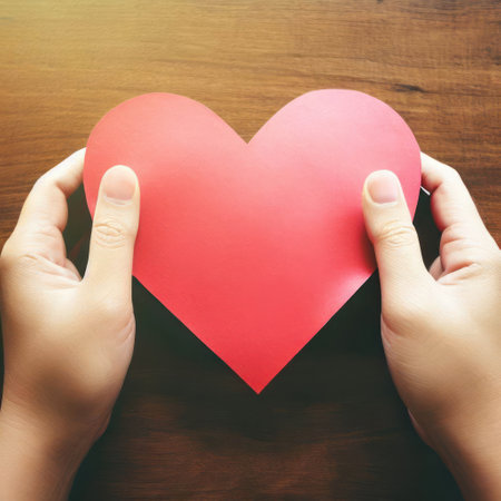Hand holding heart shaped paper against wooden table background.Generative AIの素材