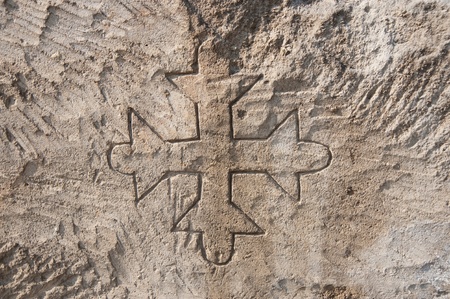 Cristian cross in a stone surface, at tuff quarry
