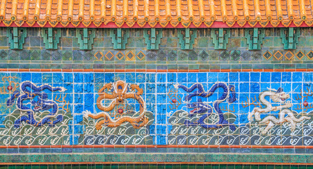 White dragon on the wall of a public Chinese temple. Dragon is commonly found in all Chinese architecture as it is a symbol of strength, power, and good fortune.の写真素材