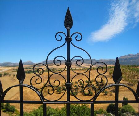 Metal Fence and landscape in Ronda, Spainの写真素材