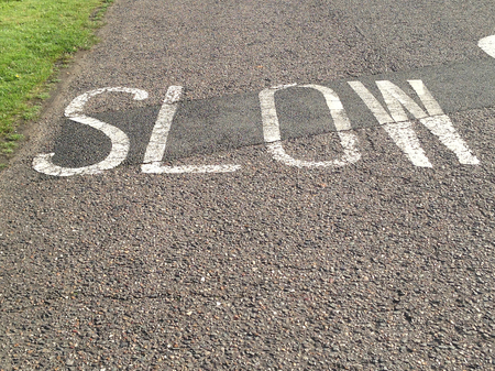 Slow sign on a road in Englandの写真素材