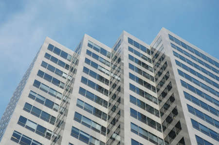 a corporate skyscraper against the blue sky