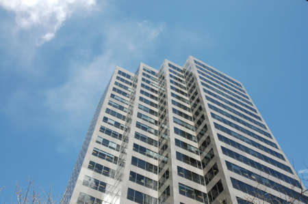 a corporate skyscraper against the blue sky