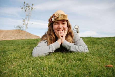 young girl is enjoying herself in green fieldの写真素材