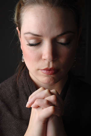 a woman is praying to god with hope