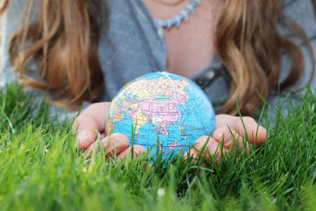 earth is being held by a little girl's hands(shows asia)の写真素材