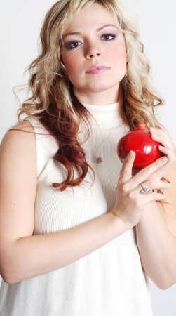 beautiful woman is holding a fruit in her handsの写真素材