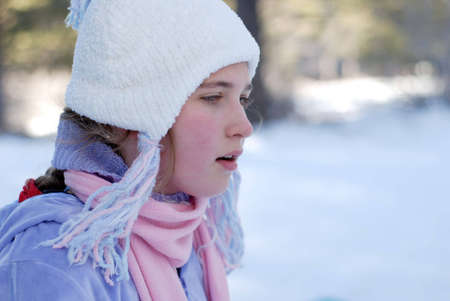 young girl is playing in the snow