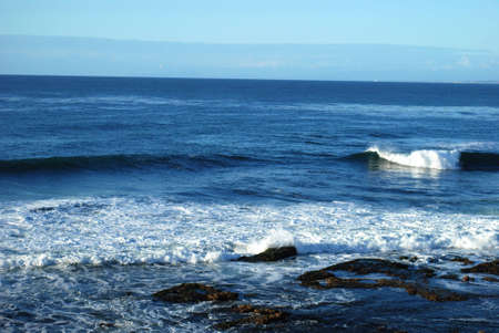 beautiful landscape with blue waves crashing to the shore