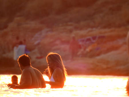 Light Reflection on The Sea during sunset and swimmers in Mediterranean Greece July 6th 2021のeditorial素材