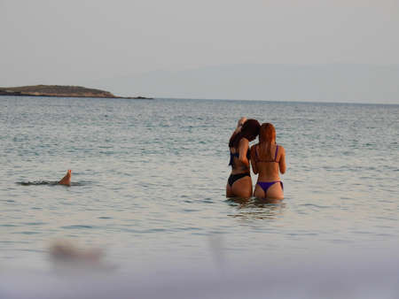 Young women on the sea during sunset July 6th 2021 Greeceのeditorial素材