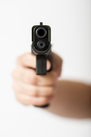 Hand holding a gunの写真素材