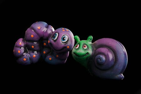 color-coded cartoon statues made appear slimy or glossy using oilの写真素材