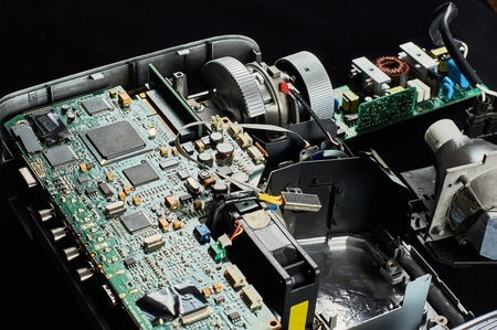 disassembled DLP projector on a black velvet background