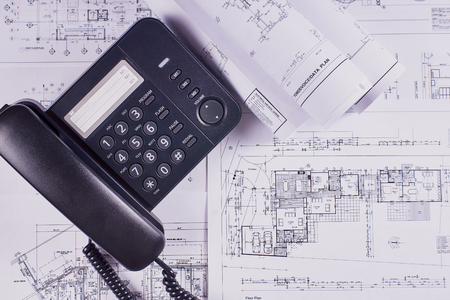 Engineering background. Construction drawings of buildings and structures next to phone. Close-up.の写真素材