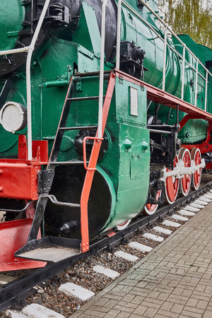 Old steam locomotive standing on rails, vintage train, close-up