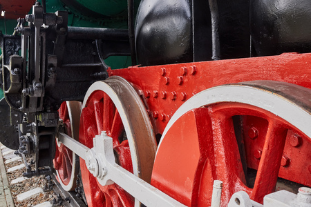 Steel wheels old steam locomotive standing on rails, vintage train, close-up