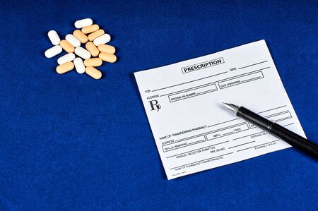 prescription, pills and pen on blue velvet backgroundの写真素材