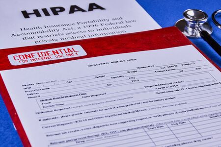 Health Insurance Portability and accountability act HIPAA, red folder with inscription confidential,...