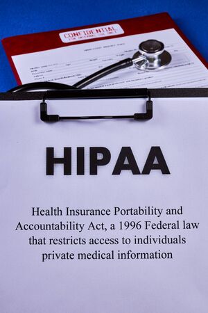 Health Insurance Portability and accountability act HIPAA, red folder with inscription confidential, medication request form and stethoscope on a blue velvet background. Close-upの写真素材