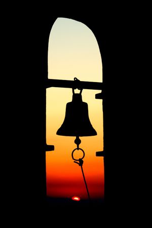 Bell on a greek chapel at sunsetの写真素材