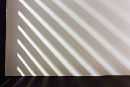 Abstract line pattern from light and shadows on wall