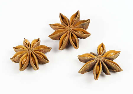 Three open fruits of star anise (Illicium verum) showing the seeds are arranged in a triangle.の写真素材