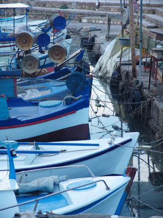An evening view of a harbor with boats and small yachtsの写真素材