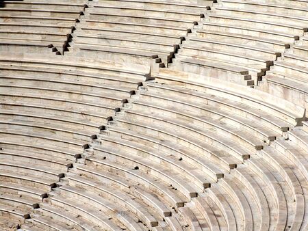 Ruins of an ancient greek Amphitheater in Athens, rows of seats and steps