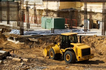 A yellow buldozzer on a construction site
