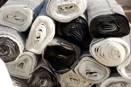 Rolls of industrial plastic cover of black and white colorsの写真素材