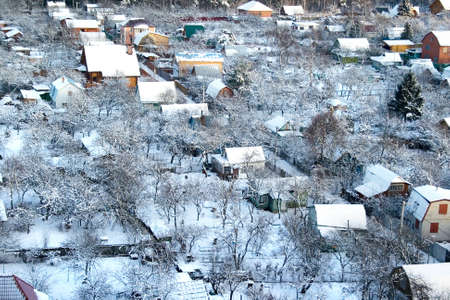 A top view of a snowed village by a sunny winter dayの写真素材