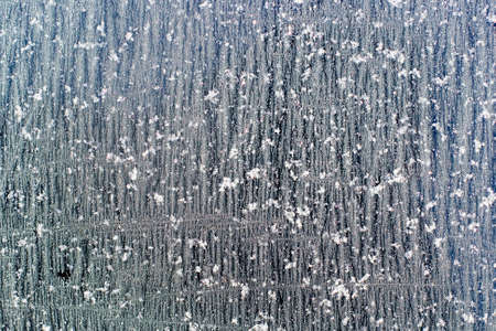 A glass covered with ice crystals in rows as a background textureの写真素材