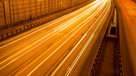 A long exposure shot of night city traffic on a highwayの写真素材