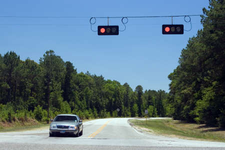 A road crossing and a car standing on red lightsの写真素材