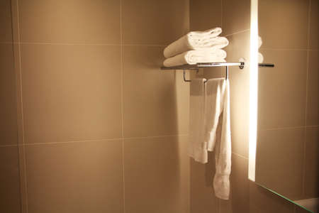 Hotel bathroom with clean white towels and copy space to be used as a backgroundの写真素材