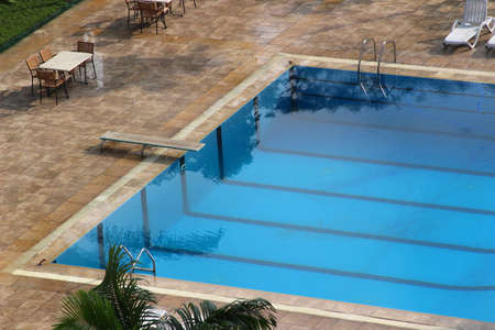 A clean open swimming pool with a plankの写真素材