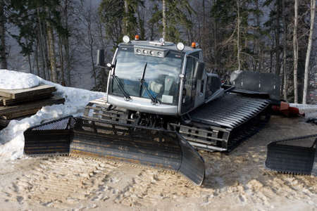 View of a small shining snow tracktor to level snow and help sportsmenの写真素材