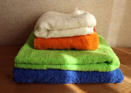 Close view of a pile of four soft colored towelsの写真素材