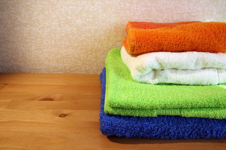 Closeup of four soft colorful towels with some copy space on the leftの写真素材