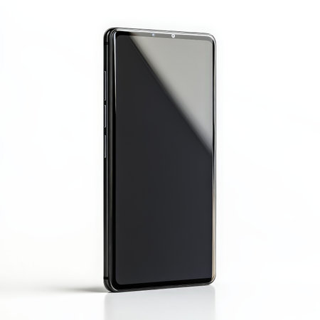 A black cell phone with a black screen. The phone is laying on a white background