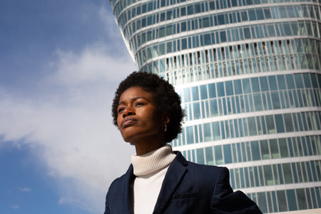 Portrait of young african american businesswoman in front of office buildingの写真素材